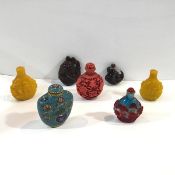 A group of seven Chinese snuff bottles: two in yellow Peking glass; one in red overlay Peking glass;