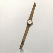 A Tissot lady's 9ct gold wristwatch, the circular silvered dial with baton numerals on a gold mesh