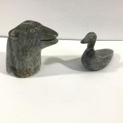 Two Inuit stone carvings: the head of a polar bear and a duck; the bear signed "David" to the base