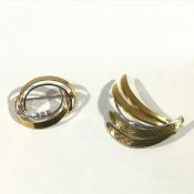 Two vintage diamond-set brooches: the first stamped 18k, set with three round brilliant-cut stones