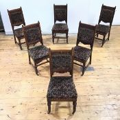 A set of six Aesthetic oak dining chairs in the style of Bruce Talbert, each carved top rail
