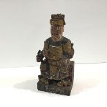 A Chinese carved, painted and gilt wood figure of a seated Emperor in the Ming style, modelled