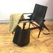 A teak and leather safari chair, of typical form with turned components and brass fittings, in its