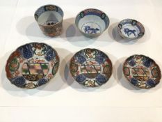 A group of Chinese Imari porcelain, comprising a graduated set of three shallow footed bowls, each