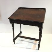 A varnished wooden child's desk by Tri-ang, the raised top with three quarter gallery, incorporating