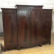 A Scottish George IV mahogany breakfront wardrobe, the raised central section with projecting