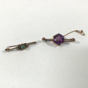 An amethyst bar brooch, the hexagonal-cut stone on a knife edge bar with sphere terminals, with