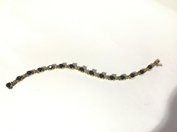 A 9ct gold sapphire and diamond bracelet, the round-cut sapphires claw-set between fancy links