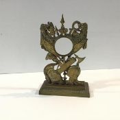 A late 19th century bronze pocket watch stand, cast with military symbols of the Ancient World