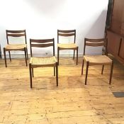 A set of four Danish dining chairs, c. 1965, each backed with a pair of shaped rails above a woven