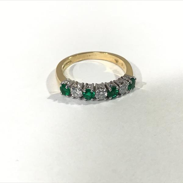 A seven stone emerald and diamond ring, the alternating round-cut emeralds and brilliant-cut