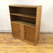 A 1930's oak bookcase cabinet by Robert John Anderson of Edinburgh, the rectangular top over two