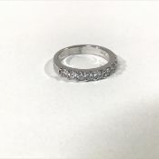 A seven stone diamond ring, the uniform row of round brilliant-cut diamonds set in an 18ct white