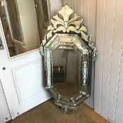 An etched wall mirror in the Venetian taste, the shaped ocatagonal plate within a mirror-inset frame