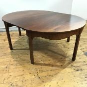 A George III mahogany dining table, c. 1760, the oval top enclosing a single leaf, above an