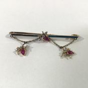 An Edwardian 15ct gold ruby and diamond-set bug bar brooch the rhodium plated bar set centrally with