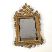 A small 18th century giltwood frame, enclosing a distressed rectangular mirror plate within a