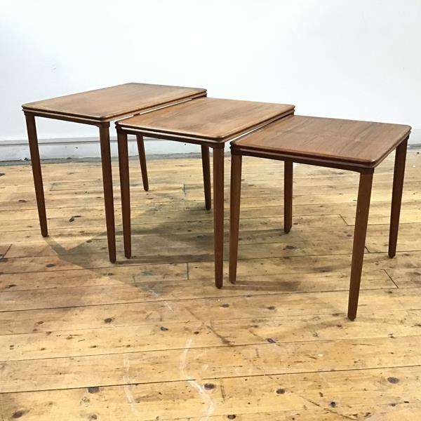 E. W Bach: A set of three Danish teak graduated tables, each rectangular top with moulded border,