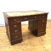 An Edwardian walnut pedestal desk, the distressed leather writing surface and moulded edge above