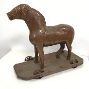 A late 19thc. child's toy horse, the metal body and legs with a repair to torso, with replacement