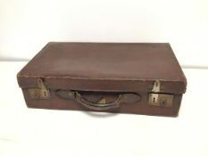 A 1930s/40s travelling case in brown leather with canvas interior and with a circular red, black and