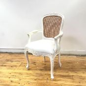 A modern white painted Louis XVI style armchair, the cane back within a moulded frame embellished