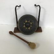 An early 20thc dinner gong complete with stand and beater, lacking hanging strings (h.24cm x 26cm