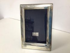 A modern Sheffield silver Christening photograph frame with teddy bear decoration (19cm x 14cm)