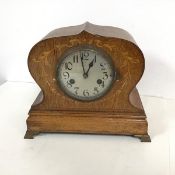 A mantle clock, c.1900, the cartouche shaped frame with inlaid floral and ribbon decoration, with