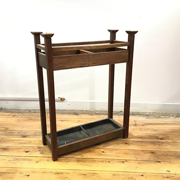 An Arts & Crafts stick stand, c.1900, the rectangular frame with projecting finials, single division