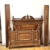 A French walnut three quarter bed, c.1900, the headboard with central urn finial above a fluted