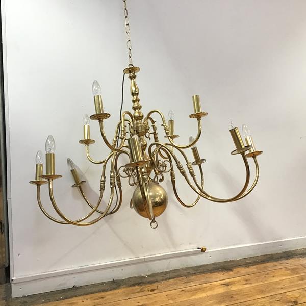 A Dutch style brass chandelier with a upper tier of four arms above a lower tier of eight arms,