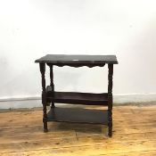 An Edwardian mahogany magazine stand, the rectangular top with undulating edge above a dished