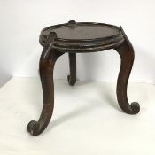 A Chinese hardwood jardiniere stand, the circular dished top on cabriole legs ending in scroll