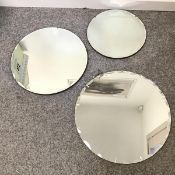 A set of three graduated circular mirrors, all with scalloped bevelled plate (largest: d.55cm)