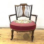 A late Victorian walnut boxwood and bone inlaid tub chair in the Neoclassical taste, the tablet
