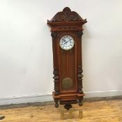 A Vienna style wall clock, the scroll pediment and moulded frieze applied with bosses, above an