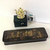 A small hand painted enamelled teapot with floral decoration, produced in support of Trade Plus Aid,