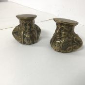 A pair of brass sash window stops in the form of Portly Gentlemen with Hats (each measuring h.6cm