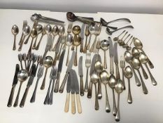 A large assortment of Epns cutlery including dinner knives, dinner forks, cake forks, serving