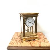 A gilt brass four glass mantel clock, the circular white enamelled roman dial inscribed Angelus, the