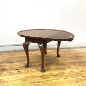 A mahogany coffee table in the style of Wylie & Lochhead, Glasgow, the oval top with raised piecrust