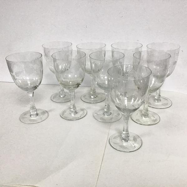A set of nine cut glass wine glasses with floral decoration to bowl and base (each: h.18cm x d.