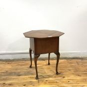 A 1920s walnut sewing table, the octagonal hinged top with quarter veneering, enclosing a fabric