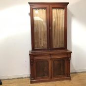 A Victorian mahogany bookcase top on an associated base, the projecting cornice above a pair of