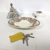 A mixed lot including a German figurine with floral border, a heart shaped dish and a collection