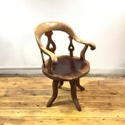 A Victorian mahogany and elm desk chair, the hoop shaped back and pierced splat above a moulded