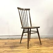 A set of four 1960s Ercol stick back chairs, the plain top rail supported by turned spindles,