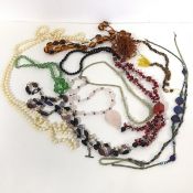 A selection of costume jewellery necklaces including paste and glass beads and pearls and a bead