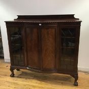An Edwardian mahogany bow fronted display cabinet, the raised gallery back and rectangular top above